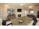 Staged living room featuring an elegant fireplace and a smooth transition into dining area at 4938 Sunset Ridge Ct, Charlotte, NC 28269