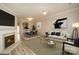 Open-concept living room with fireplace flows into a dining area, great for entertaining at 4938 Sunset Ridge Ct, Charlotte, NC 28269