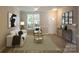 Cozy living room with neutral walls, wood floors, and ample natural light from large windows at 4938 Sunset Ridge Ct, Charlotte, NC 28269