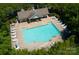 Aerial view of a community pool with lounge chairs, umbrellas, and seating areas at 4938 Sunset Ridge Ct, Charlotte, NC 28269