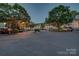 Exterior shot of community with landscaping, parking, and well-maintained buildings under evening lighting at 5009 Sharon Rd # E, Charlotte, NC 28210