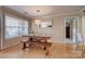 Bright dining room with a large window and natural wood table at 5009 Sharon Rd # E, Charlotte, NC 28210