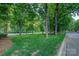 Beautifully landscaped grounds with mature trees and manicured lawn providing a serene setting at 5009 Sharon Rd # E, Charlotte, NC 28210