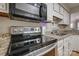 Close-up of kitchen featuring stainless steel oven and granite countertops at 5009 Sharon Rd # E, Charlotte, NC 28210