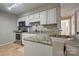 Kitchen with granite countertops, white cabinets and stainless steel appliances at 5009 Sharon Rd # E, Charlotte, NC 28210