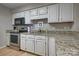 Kitchen with granite countertops, stainless steel appliances, and white cabinets at 5009 Sharon Rd # E, Charlotte, NC 28210