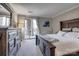Comfortable main bedroom with wood furniture, large windows, and relaxing balcony access at 5009 Sharon Rd # E, Charlotte, NC 28210