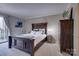 Comfortable main bedroom with wood furniture and serene decor at 5009 Sharon Rd # E, Charlotte, NC 28210