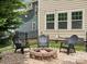 Cozy backyard fire pit area with three chairs, ideal for gathering and enjoying outdoor evenings at 5013 Hamilton Mill Dr, Waxhaw, NC 28173