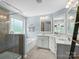 Well-lit bathroom with dual sinks, large mirrors and stylish fixtures, offering ample space at 5013 Hamilton Mill Dr, Waxhaw, NC 28173