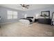 Spacious bedroom with large window, ceiling fan, and neutral decor, creating a serene atmosphere at 5013 Hamilton Mill Dr, Waxhaw, NC 28173