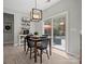 Dining area with sliding glass doors leading to outdoor patio and pool at 5013 Hamilton Mill Dr, Waxhaw, NC 28173