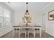 Elegant dining room featuring a stylish light fixture, wainscoting, and a large window at 5013 Hamilton Mill Dr, Waxhaw, NC 28173