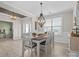 Bright dining room with hardwood floors, stylish lighting, and a view into the living area at 5013 Hamilton Mill Dr, Waxhaw, NC 28173