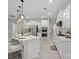 Bright, open kitchen featuring white cabinets, stainless steel appliances, and island with seating at 5013 Hamilton Mill Dr, Waxhaw, NC 28173