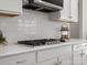 Modern kitchen featuring white cabinets, subway tile backsplash, and stainless steel gas range at 5013 Hamilton Mill Dr, Waxhaw, NC 28173