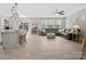 Spacious living room with large windows, ceiling fan, and modern decor at 5013 Hamilton Mill Dr, Waxhaw, NC 28173
