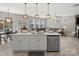 Open floor plan showing kitchen island, dining table, and living room with a large grey sofa at 5013 Hamilton Mill Dr, Waxhaw, NC 28173