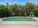 A beautiful pool is surrounded by mature trees, plants, and chairs, with a lush lawn enhancing the outdoor experience at 5013 Hamilton Mill Dr, Waxhaw, NC 28173