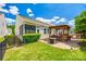 Landscaped backyard featuring a paved patio, outdoor seating under a pergola, and lush green grass at 5025 Kinross Ln, Indian Land, SC 29707