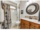 Bright bathroom featuring a tub-shower, toilet, stylish vanity, and a unique decorative shower curtain at 5025 Kinross Ln, Indian Land, SC 29707
