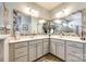 Bright primary bath with double sinks, decorative mirrors, and a view of the glass shower at 5025 Kinross Ln, Indian Land, SC 29707