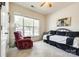 Bright bedroom with a large window, recliner, and a bed with a black and white comforter at 5025 Kinross Ln, Indian Land, SC 29707