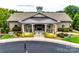 Community clubhouse with stone accents, covered porch, and manicured landscaping at 5025 Kinross Ln, Indian Land, SC 29707