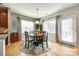 Dining area features a round wooden table, wooden floors, and ample natural light at 5025 Kinross Ln, Indian Land, SC 29707