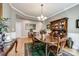 Spacious dining room featuring hardwood floors, wainscoting, and modern chandelier at 5025 Kinross Ln, Indian Land, SC 29707