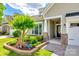 Landscaped front yard with healthy green bushes, brick edging, and a stone-accented front entrance at 5025 Kinross Ln, Indian Land, SC 29707