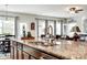Kitchen island features a large sink and granite countertops with bar seating, perfect for entertaining guests at 5025 Kinross Ln, Indian Land, SC 29707