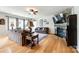 Spacious living room with hardwood floors, fireplace, large windows, and comfortable furniture at 5025 Kinross Ln, Indian Land, SC 29707