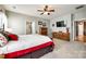 Spacious primary bedroom features a ceiling fan, dresser, and a flat screen television at 5025 Kinross Ln, Indian Land, SC 29707
