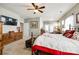 Spacious primary bedroom features a ceiling fan, dresser, and sitting area with access to a private porch at 5025 Kinross Ln, Indian Land, SC 29707
