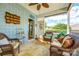 Inviting screened porch with wicker seating, ceiling fan, and serene views for relaxed outdoor enjoyment at 5025 Kinross Ln, Indian Land, SC 29707
