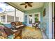 Charming screened porch featuring comfortable wicker furniture and a ceiling fan for relaxed outdoor living at 5025 Kinross Ln, Indian Land, SC 29707