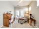 This sunlit room contains a writing desk, comfortable chair with footstool, and double doors to a porch at 5025 Kinross Ln, Indian Land, SC 29707