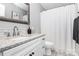 Bright bathroom features a white vanity with granite counters and a shower with tile surround at 516 Aspen Ln, Indian Trail, NC 28079
