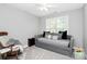Guest bedroom featuring a gray daybed, neutral colored walls and carpet, and one window at 516 Aspen Ln, Indian Trail, NC 28079