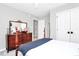Bedroom with a wooden four-poster bed, a dresser, a closet, and neutral colored walls at 516 Aspen Ln, Indian Trail, NC 28079