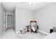 Cozy bedroom with a ceiling fan, neutral walls, and a chair with side table at 516 Aspen Ln, Indian Trail, NC 28079