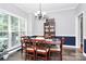 Formal dining room with hardwood floors, natural light, and elegant chandelier at 516 Aspen Ln, Indian Trail, NC 28079