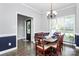 Formal dining room with hardwood floors, natural light, and elegant chandelier at 516 Aspen Ln, Indian Trail, NC 28079