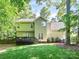 Rear view of a charming two-story home featuring a spacious yard and back deck at 516 Aspen Ln, Indian Trail, NC 28079