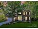 Charming brick two-story home with a well-manicured lawn and mature trees at 516 Aspen Ln, Indian Trail, NC 28079