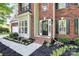 Beautiful front door and landscaping featuring a brick home exterior and mature trees at 516 Aspen Ln, Indian Trail, NC 28079