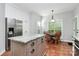 Kitchen with stainless steel refrigerator, adjacent to breakfast nook and plentiful cabinet space at 516 Aspen Ln, Indian Trail, NC 28079