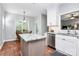 Charming kitchen with an island and a breakfast table next to a large window at 516 Aspen Ln, Indian Trail, NC 28079