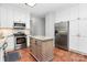 Updated kitchen with stainless steel appliances, center island and ample cabinet space at 516 Aspen Ln, Indian Trail, NC 28079